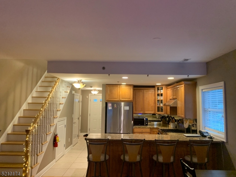 453 Springfield Avenue Berkeley Heights, NJ 07922 - Photo 4 of 13 a view of a kitchen with kitchen island stainless steel appliances a sink and cabinets