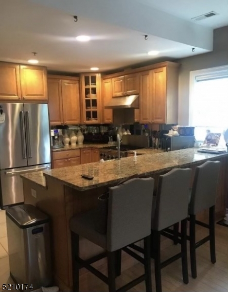 453 Springfield Avenue Berkeley Heights, NJ 07922 - Photo 6 of 13 a kitchen with granite countertop a sink stainless steel appliances and cabinets