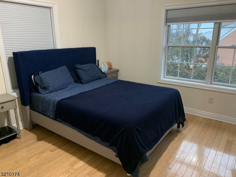 453 Springfield Avenue Berkeley Heights, NJ 07922 - Photo 8 of 13 a bed sitting in a bedroom next to a window