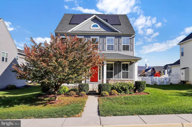 a front view of house with yard and green space