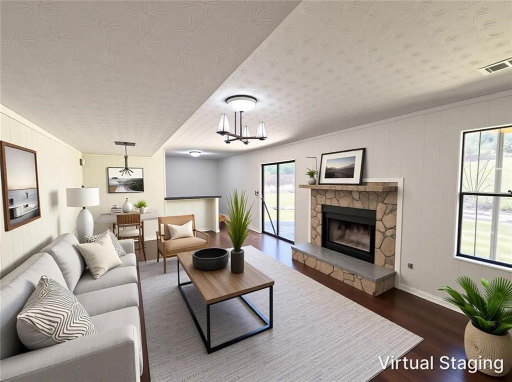 6830 Earlhurst Road Atlanta, GA 30349 - Photo 2 of 27 a living room with furniture a fireplace and a window
