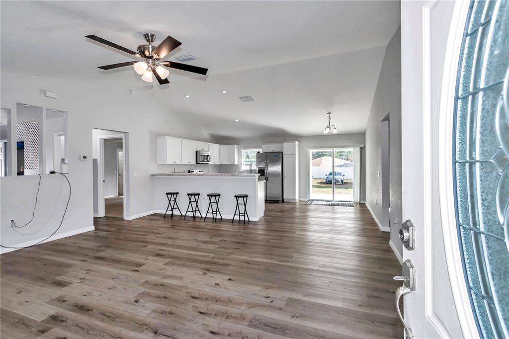 14 Maple Run Ocala, FL 34472 - Photo 11 of 43 a view of a livingroom with a furniture wooden floor ceiling fan and windows