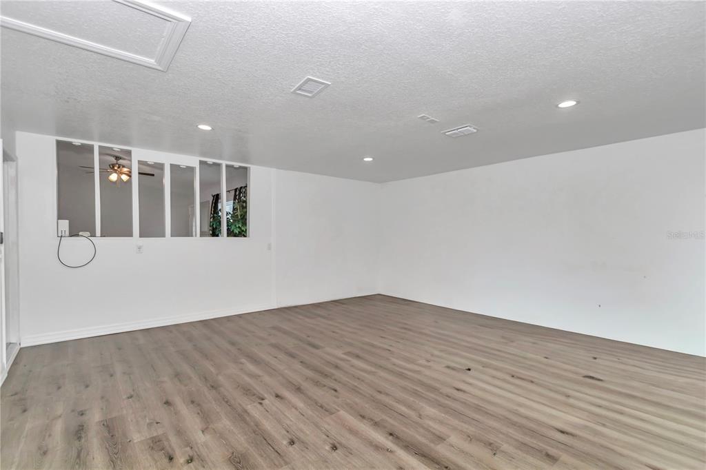 14 Maple Run Ocala, FL 34472 - Photo 14 of 43 an empty room with wooden floor and windows