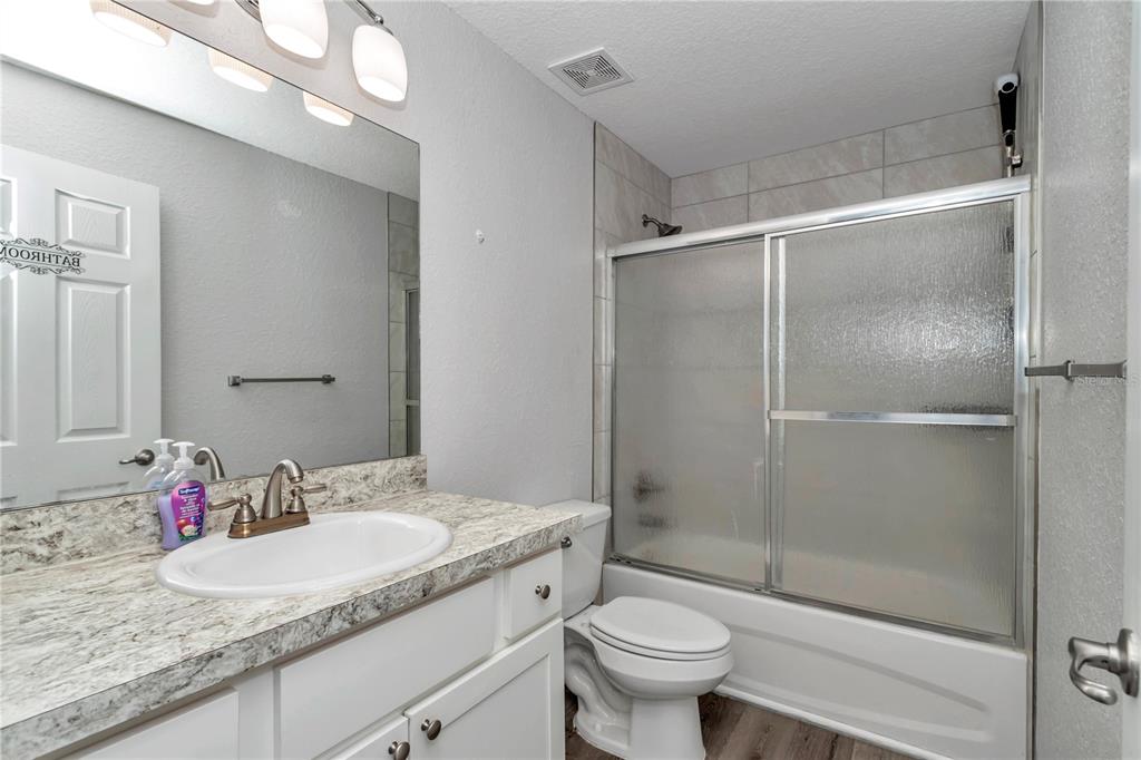 14 Maple Run Ocala, FL 34472 - Photo 30 of 43 a bathroom with a granite countertop sink a toilet and shower