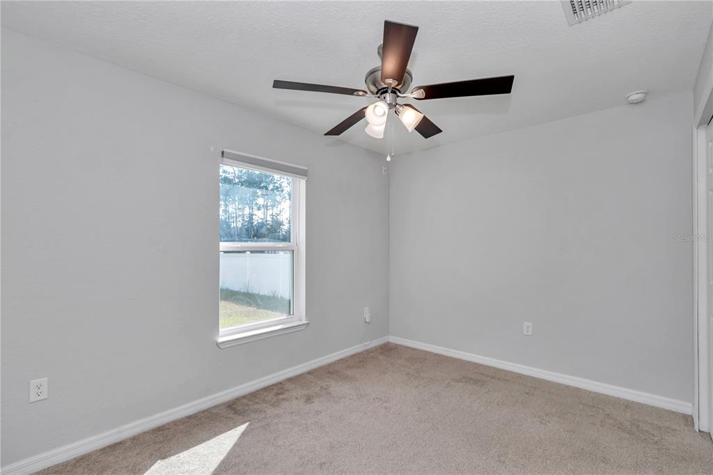 14 Maple Run Ocala, FL 34472 - Photo 31 of 43 en empty room with windows and fan