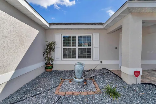 a open kitchen with stainless steel appliances granite countertop a refrigerator oven a sink dishwasher a stove and white cabinets with wooden floor