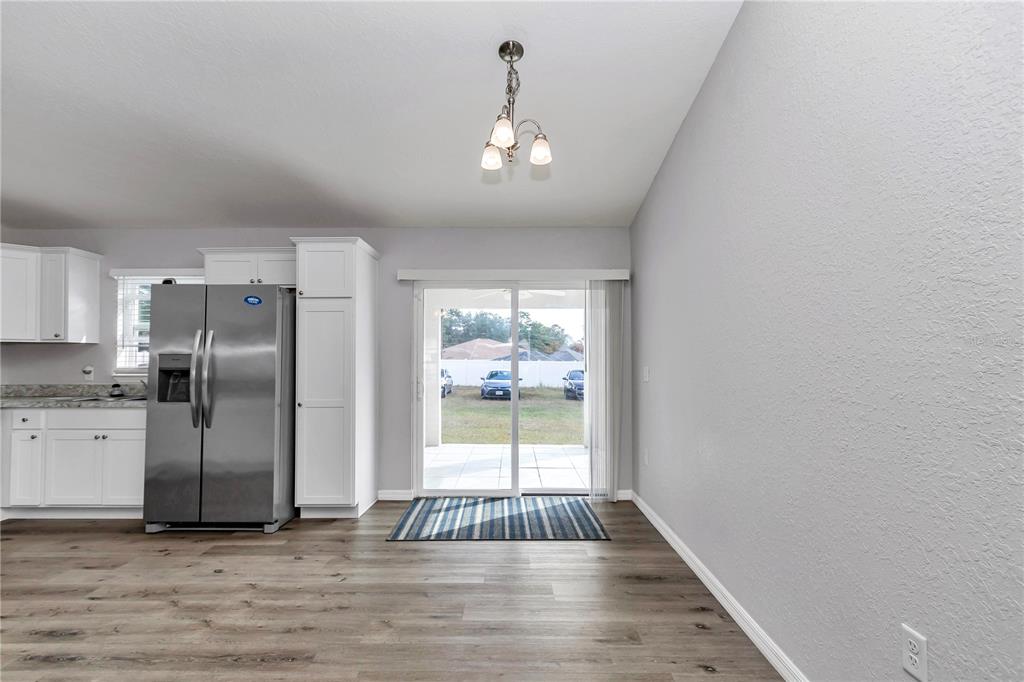14 Maple Run Ocala, FL 34472 - Photo 8 of 43 an empty room with wooden floor cabinet and windows