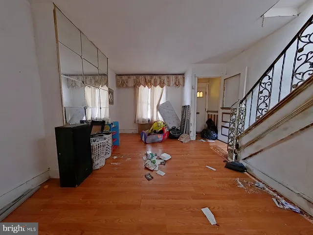 a living room with furniture a wooden floor and a large window