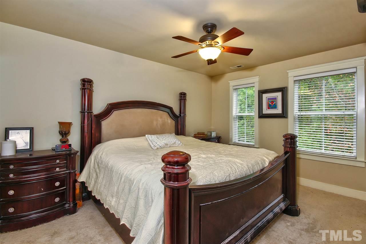 4523 All Points View Way Raleigh, NC 27614 - Photo 11 of 21 a bedroom with a bed and a chandelier