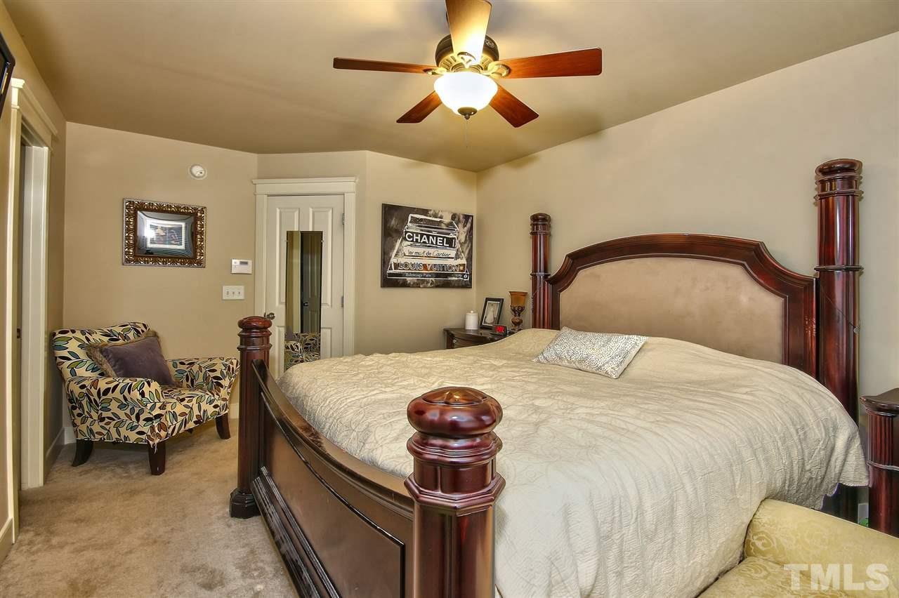 4523 All Points View Way Raleigh, NC 27614 - Photo 12 of 21 a bedroom with a bed and a chandelier