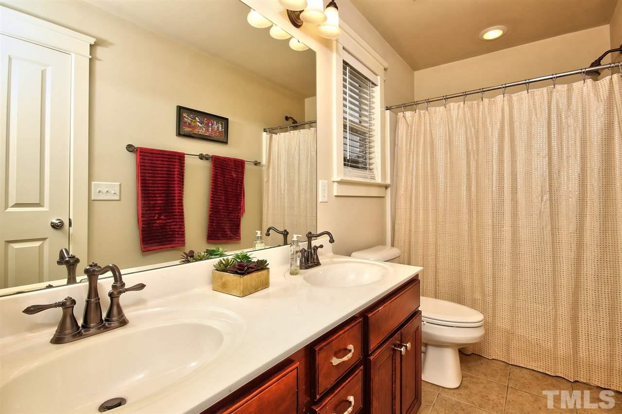 4523 All Points View Way Raleigh, NC 27614 - Photo 15 of 21 a bathroom with a double vanity sink toilet and a mirror