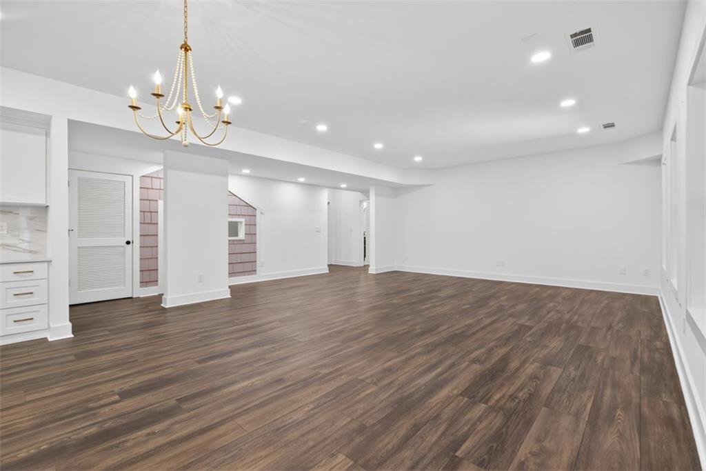 3528 North Bogan Road Buford, GA 30519 - Photo 55 of 79 a view of an empty room with wooden floor and staircase