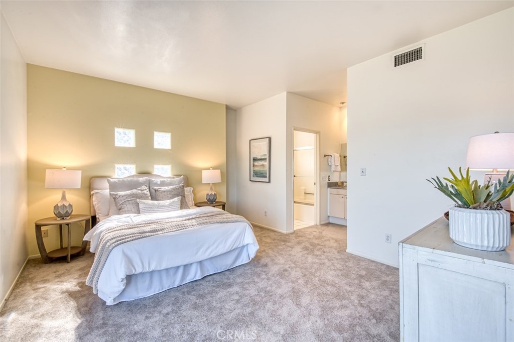 1082 Everett Place Echo Park, CA 90026 - Photo 23 of 39 a bedroom with a large bed and a potted plant