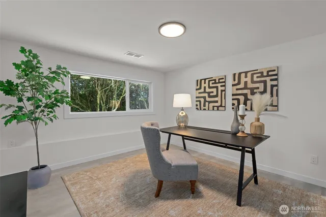 a view of a livingroom with furniture and a potted plant