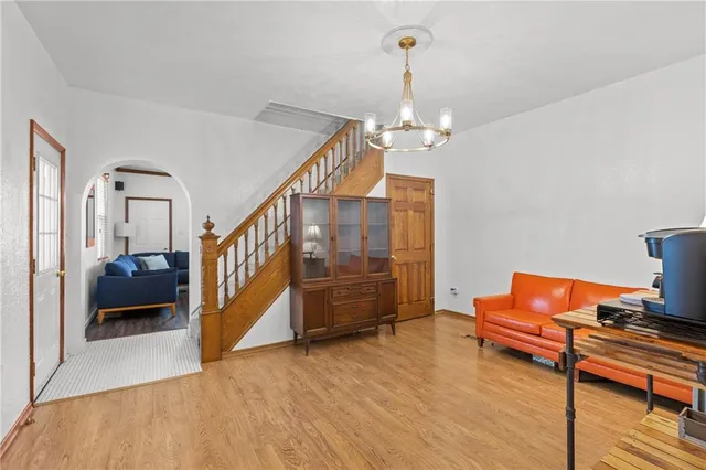 a living room with furniture and a chandelier