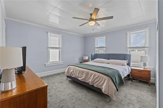 a bedroom with a bed and a ceiling fan