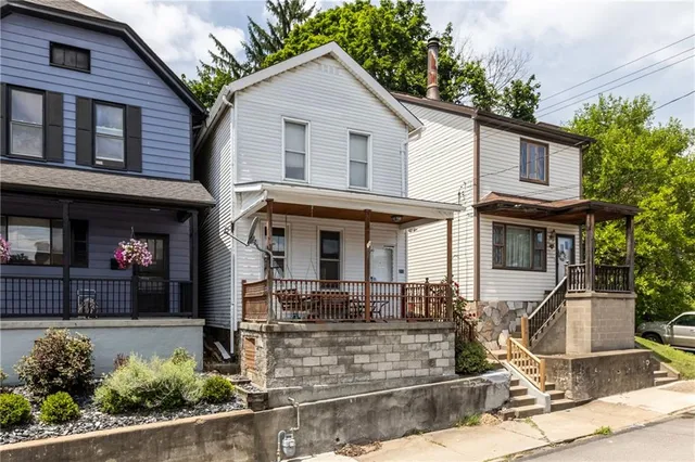 a front view of a house with garden