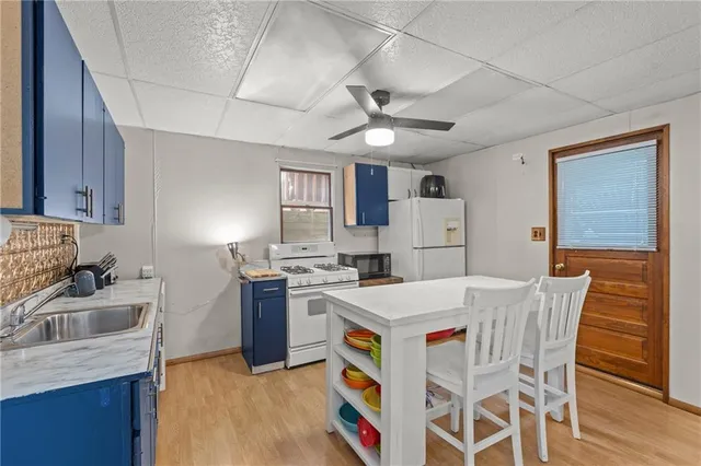 a kitchen with refrigerator cabinets and wooden floor