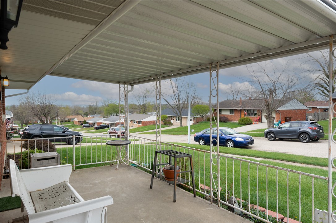 795 Spring Garden Place Dayton, OH 45431 - Photo 6 of 34 Enjoy outdoor living on this welcoming front porch, perfect for relaxation and neighborhood views.