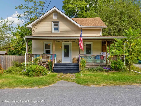 a front view of house with yard and green space