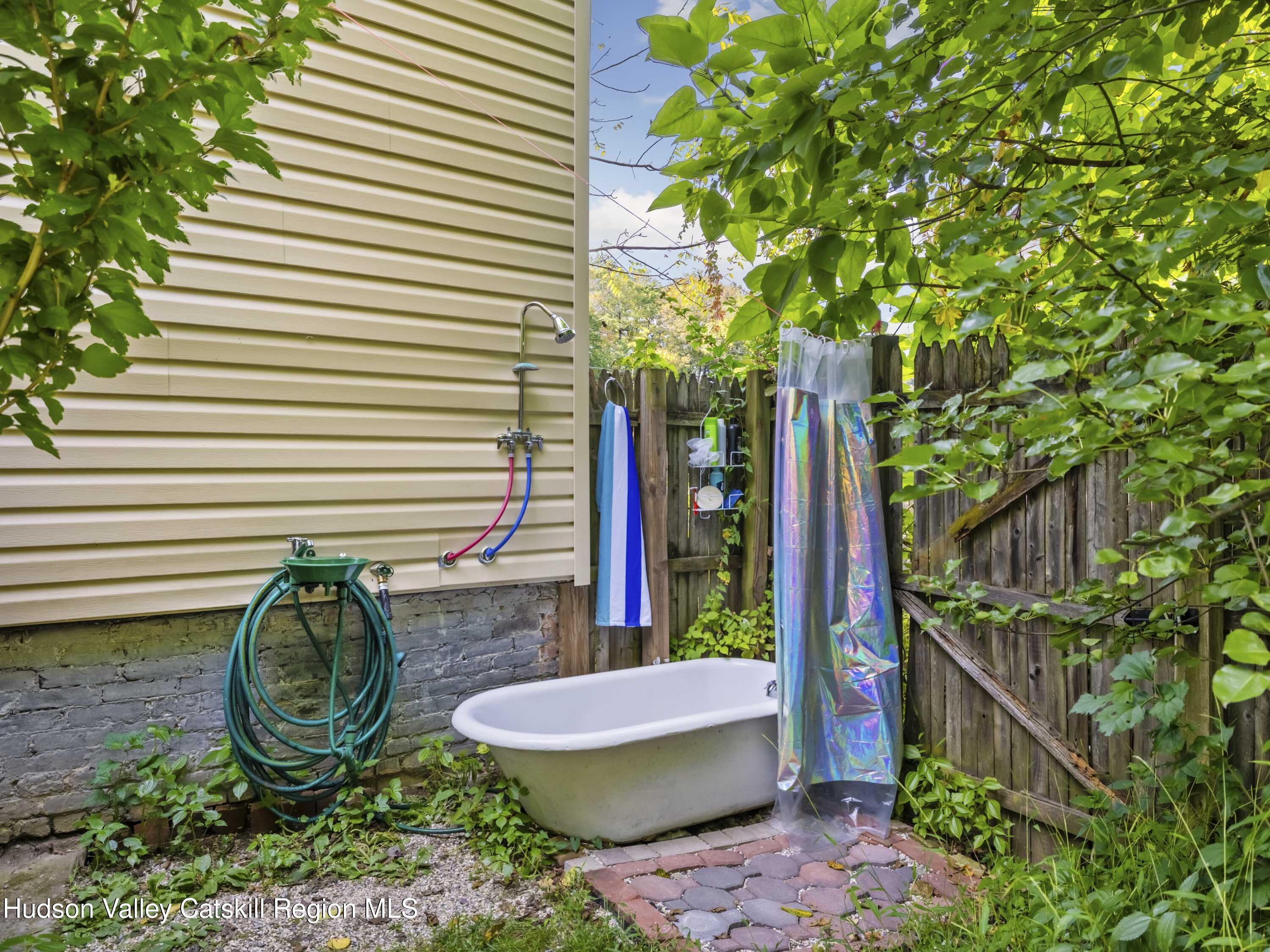 311 Spring Street Port Ewen, NY 12466 - Photo 28 of 45 a view of a backyard with plants and outdoor seating