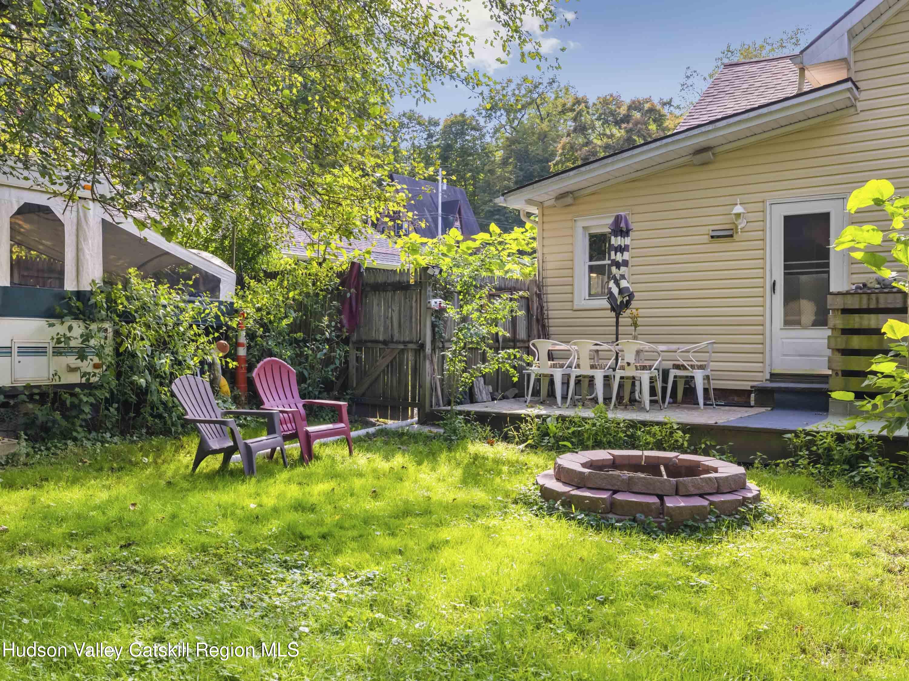 311 Spring Street Port Ewen, NY 12466 - Photo 31 of 45 a view of a chairs and table in backyard of the house