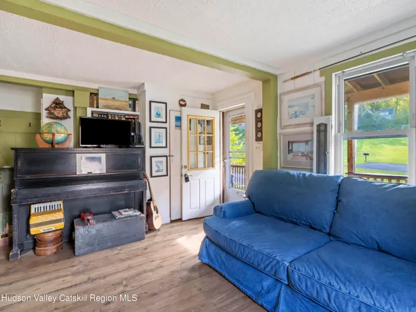 a view of living room with furniture and wooden floor
