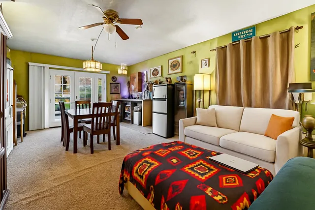 a living room with furniture a table and chairs