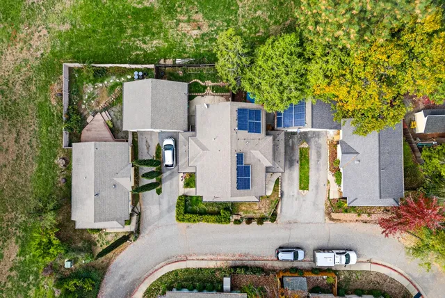 an aerial view of a house with a yard and sitting area