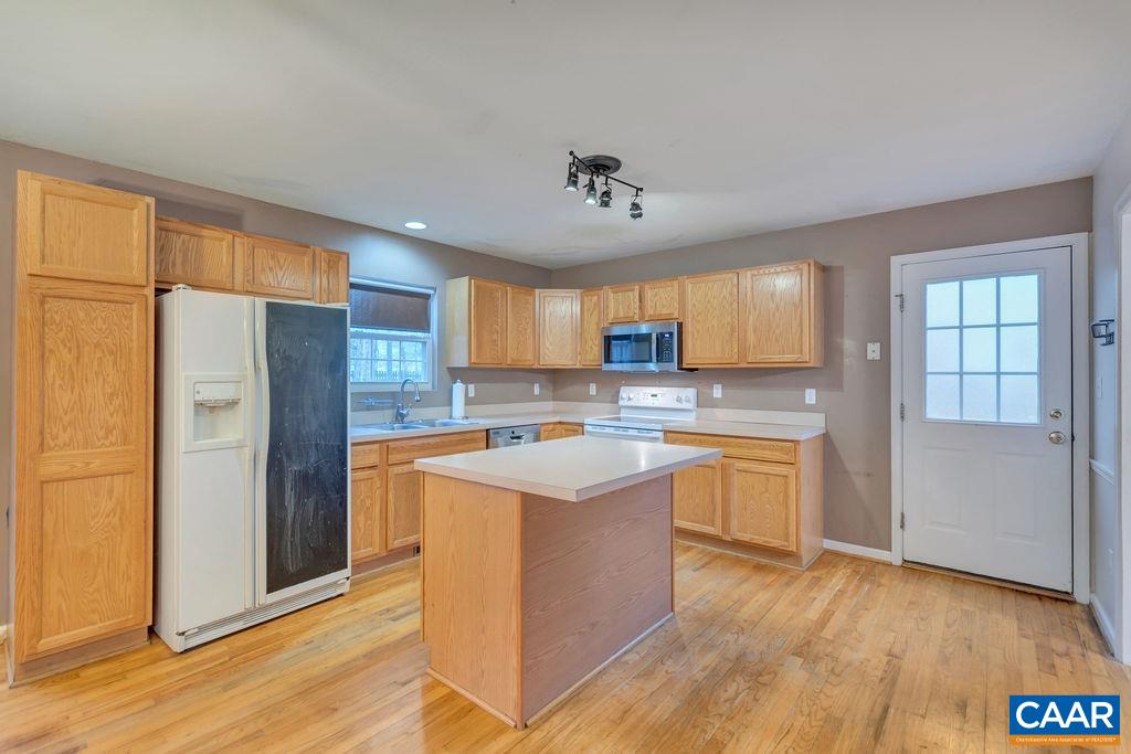 46 Laguna Road Palmyra, VA 22963 - Photo 8 of 37 a kitchen with stainless steel appliances granite countertop a refrigerator a sink dishwasher a stove and white countertops with wooden floor