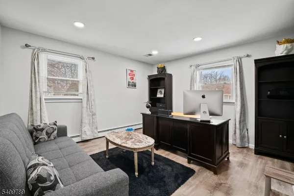 a living room with furniture a dining table and a window