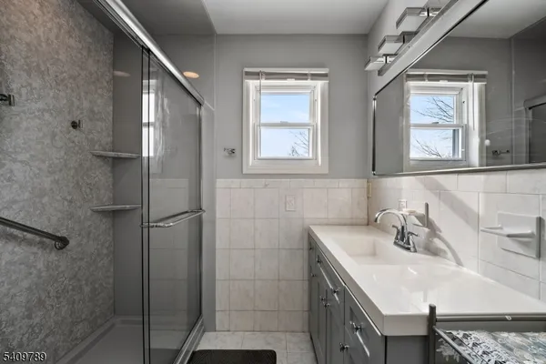 a bathroom with a sink a vanity and a mirror