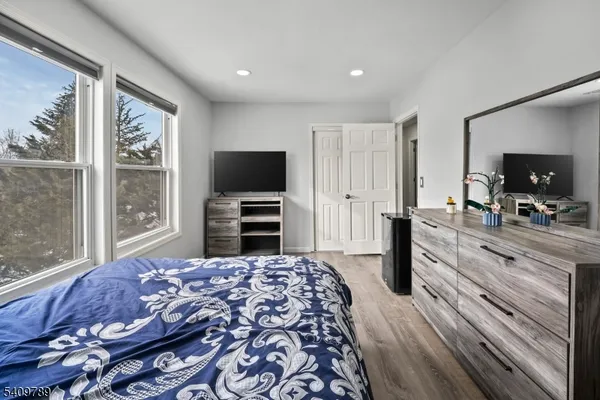 a bedroom with a bed and a flat screen television