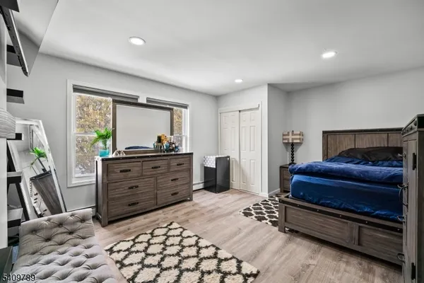 a bedroom with a bed and a dresser