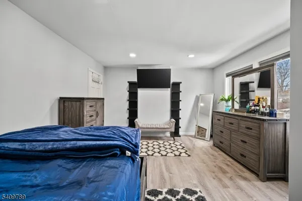 a living room with a dresser and a mirror