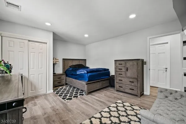 a bedroom with a bed and a dresser