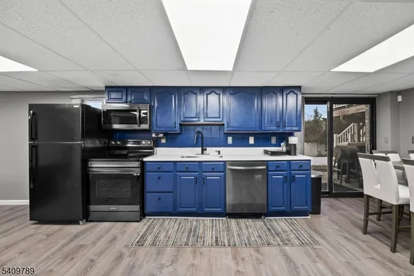 a kitchen with stainless steel appliances granite countertop a refrigerator stove and sink