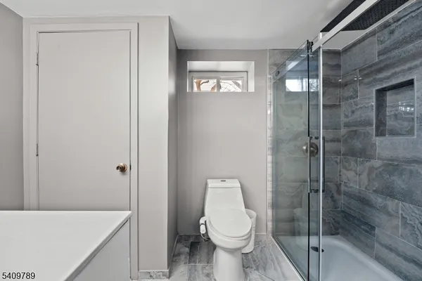 a bathroom with a toilet and a shower