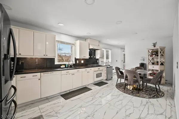 a kitchen with stainless steel appliances kitchen island granite countertop a sink and cabinets
