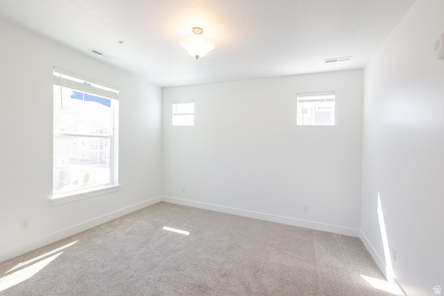 675 West 4500th South, Unit P204 Mapleton, UT 84664 - Photo 10 of 16 Bright interior space featuring light-colored carpeting, white walls, and a prominent window