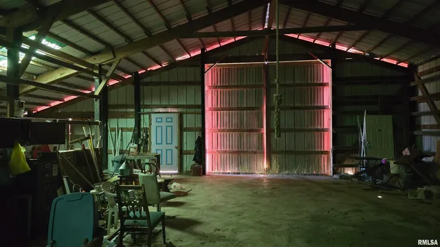 a backyard of a house with barbeque oven table and chairs