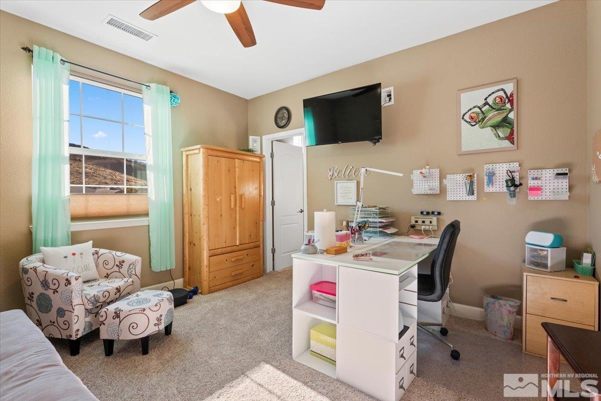 200 Noble Metal Court Reno, NV 89521 - Photo 15 of 39 a workspace with furniture and a flat screen tv