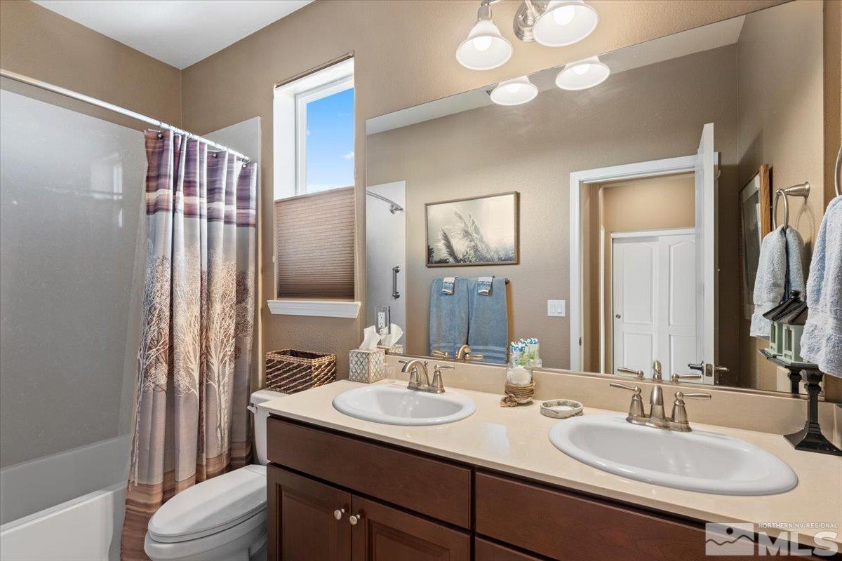 200 Noble Metal Court Reno, NV 89521 - Photo 21 of 39 a bathroom with a double vanity sink mirror and toilet