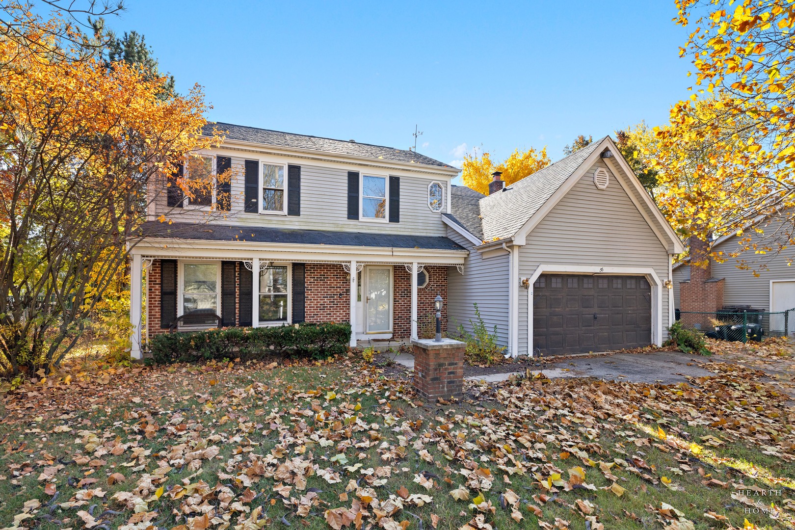 56 Huntcliff Court Fox River Grove, IL 60021 - Photo 2 of 42 a front view of a house with a garden