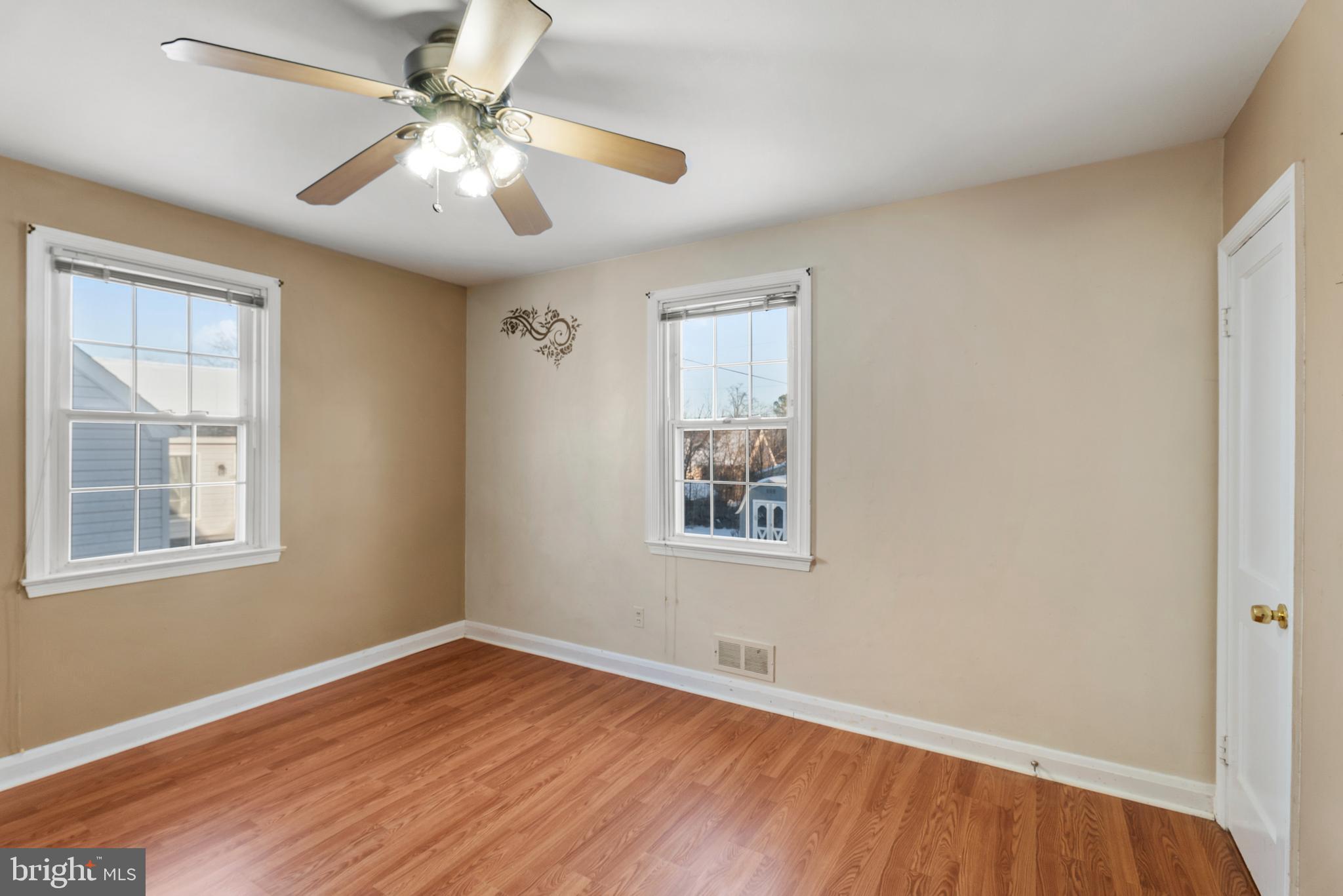 3823 Byfield Road Gwynn Oak, MD 21207 - Photo 14 of 42 a view of an empty room with wooden floor and a window