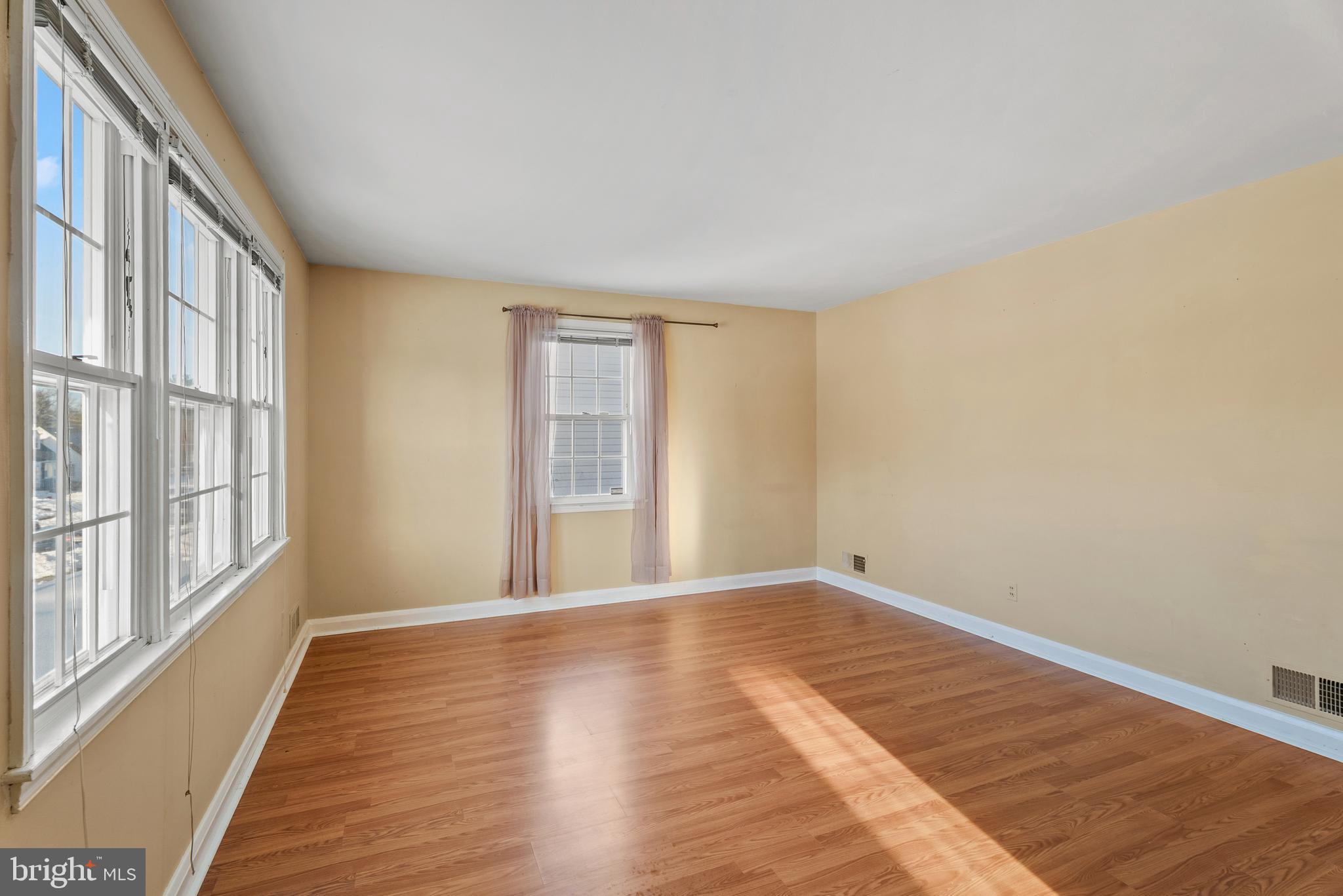 3823 Byfield Road Gwynn Oak, MD 21207 - Photo 6 of 42 a view of an empty room with wooden floor and a window