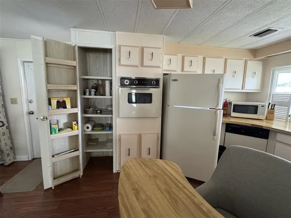 a kitchen with a refrigerator a sink and a stove