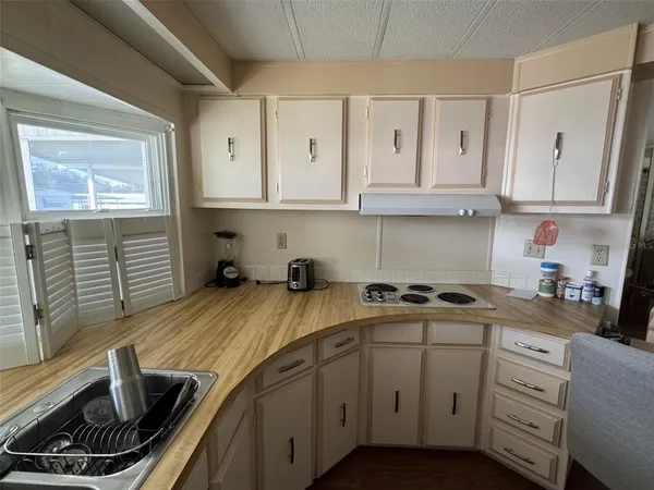 a kitchen with stainless steel appliances a stove refrigerator sink and cabinets