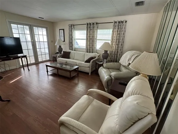 a living room with furniture and wooden floor