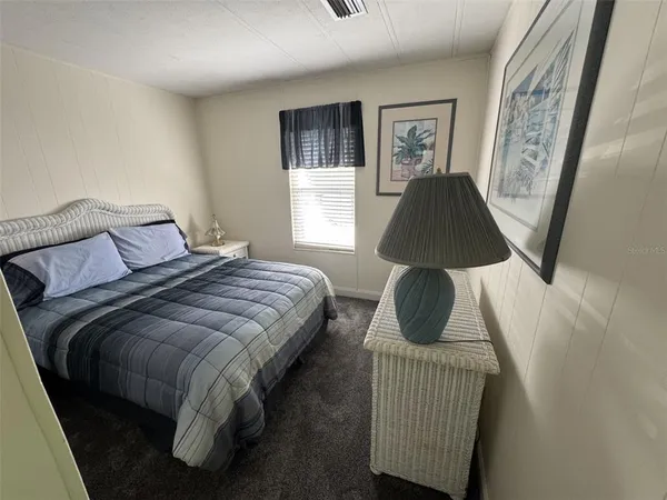 a bedroom with a bed couch and window